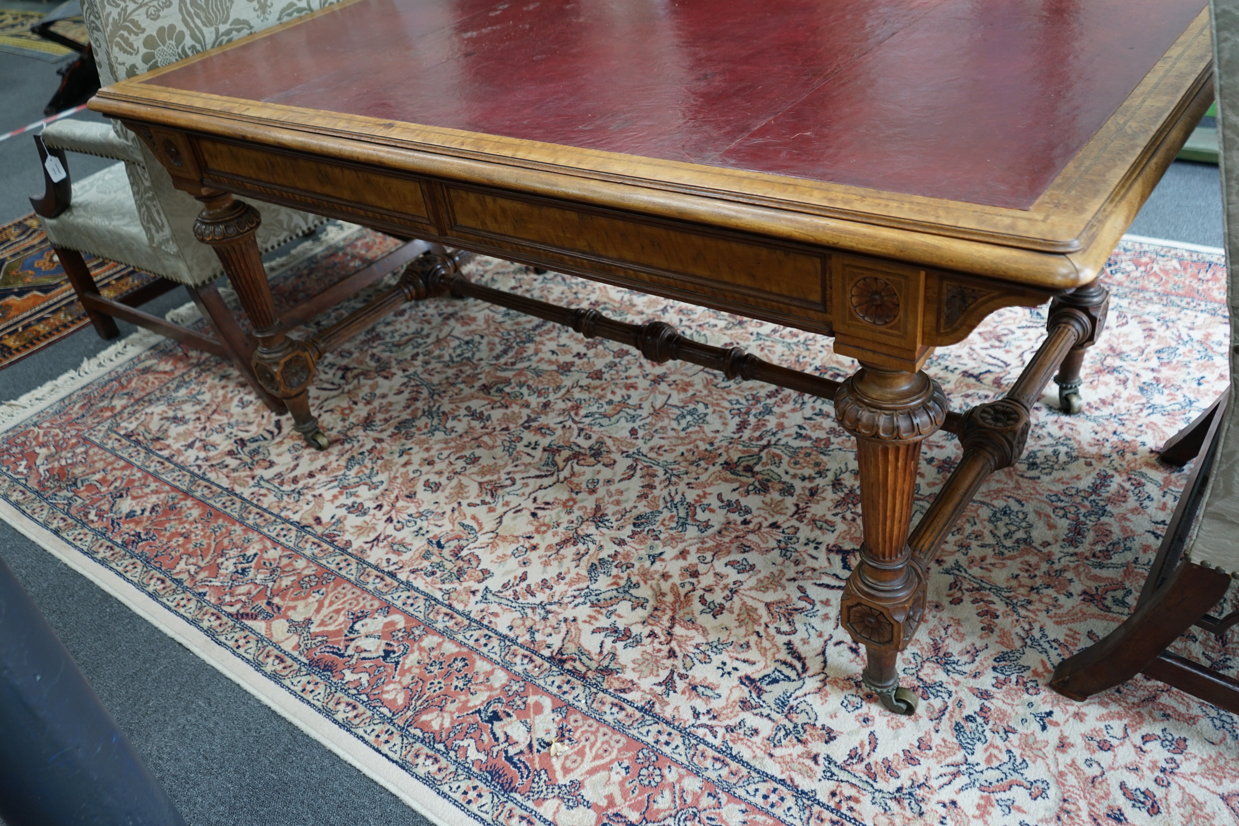 A late Victorian Holland & Sons banded satinwood two drawer library table, retailed by S & H Jewell, width 168cm, depth 96cm, height 76cm